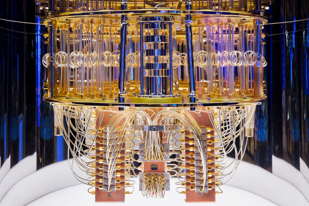 A close-up of a golden quantum computer chandelier with wires and coiled cables