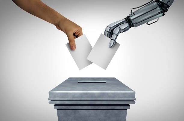 A human hand and a robotic hand each placing a ballot into a voting box