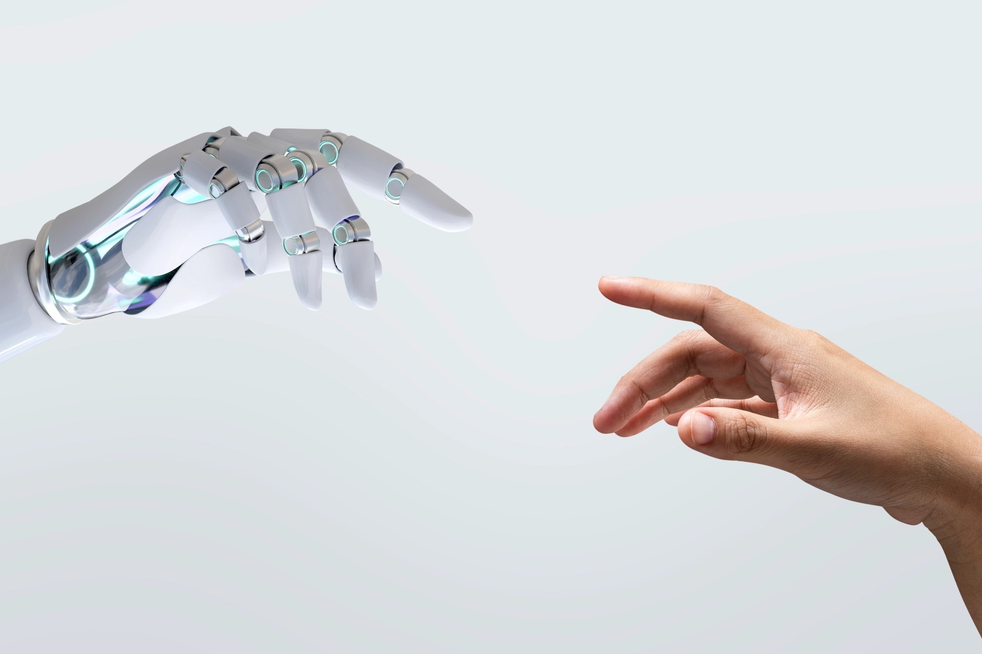 A robotic hand and a human hand reaching toward each other