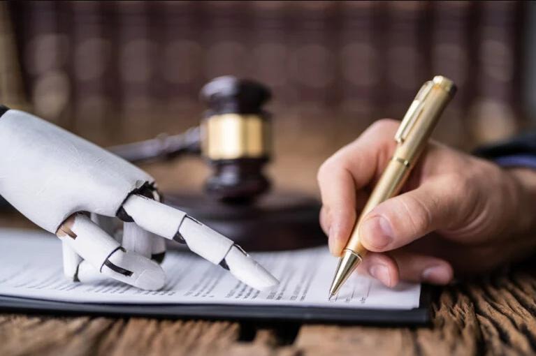 A robotic hand and a human hand each signing documents, with a judge's gavel in the background